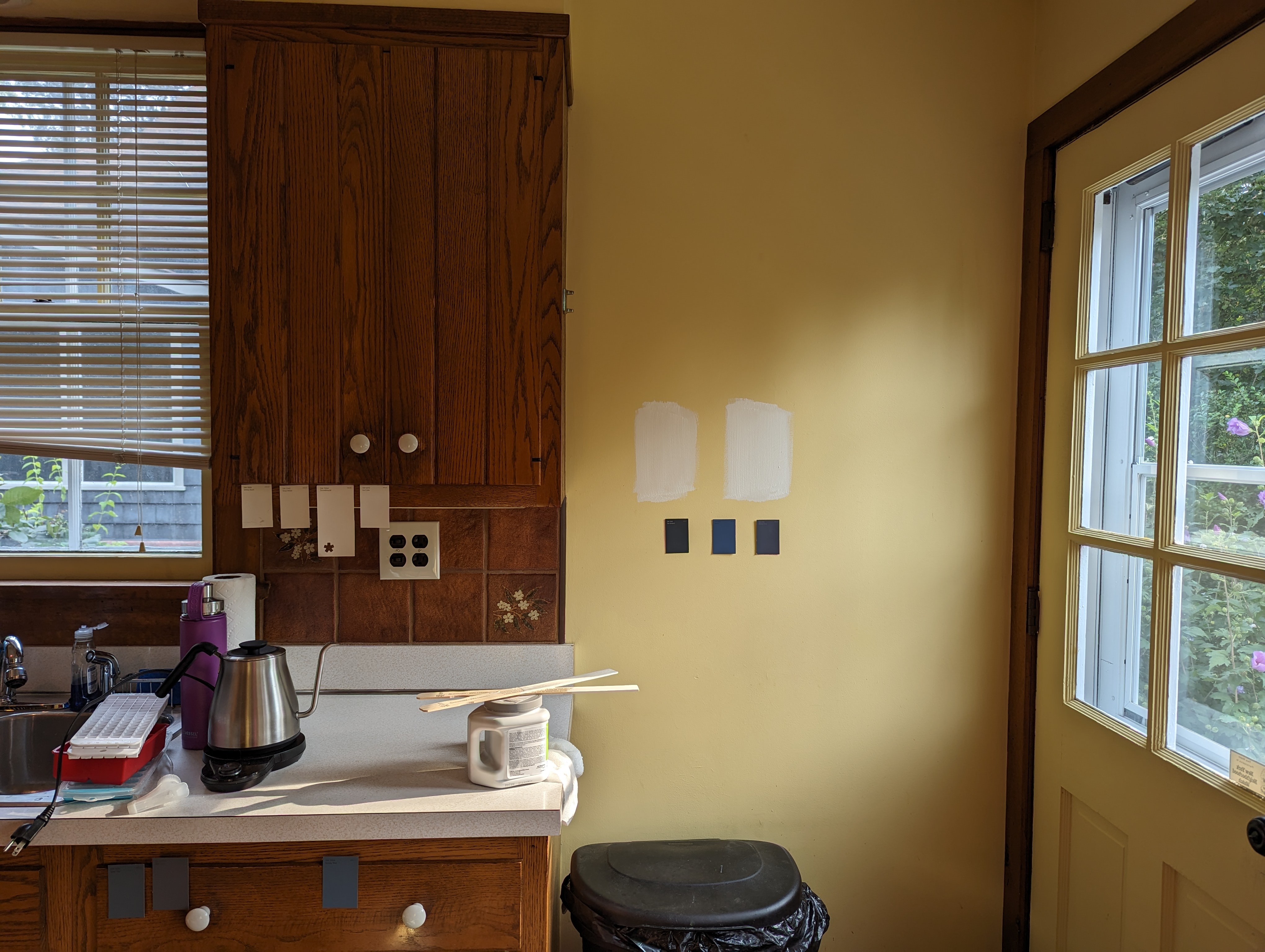 Paint swatches on a kitchen wall in a 1970s kitchen