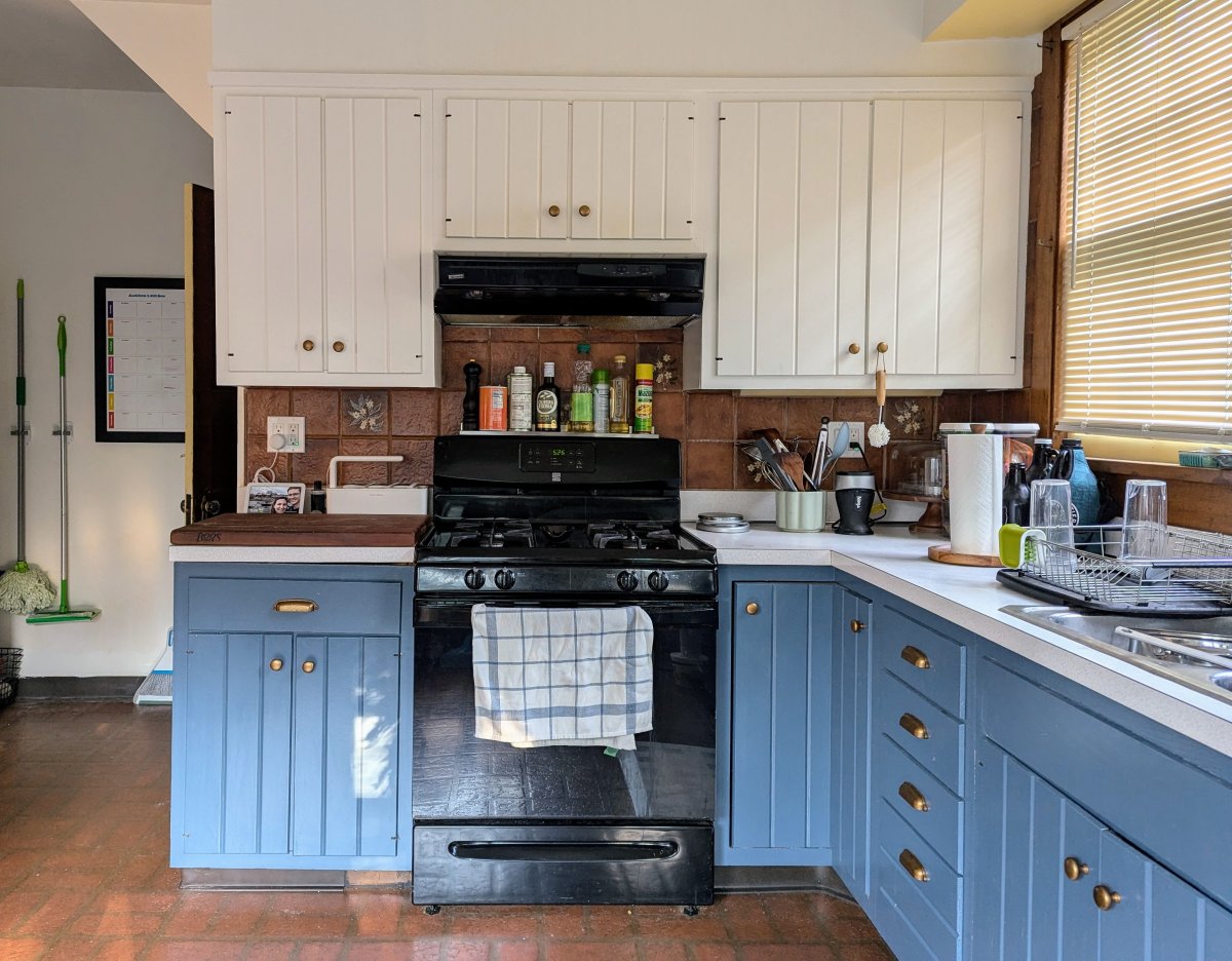 Two-tone white and blue painted kitchen cabinets in a DIY renovation