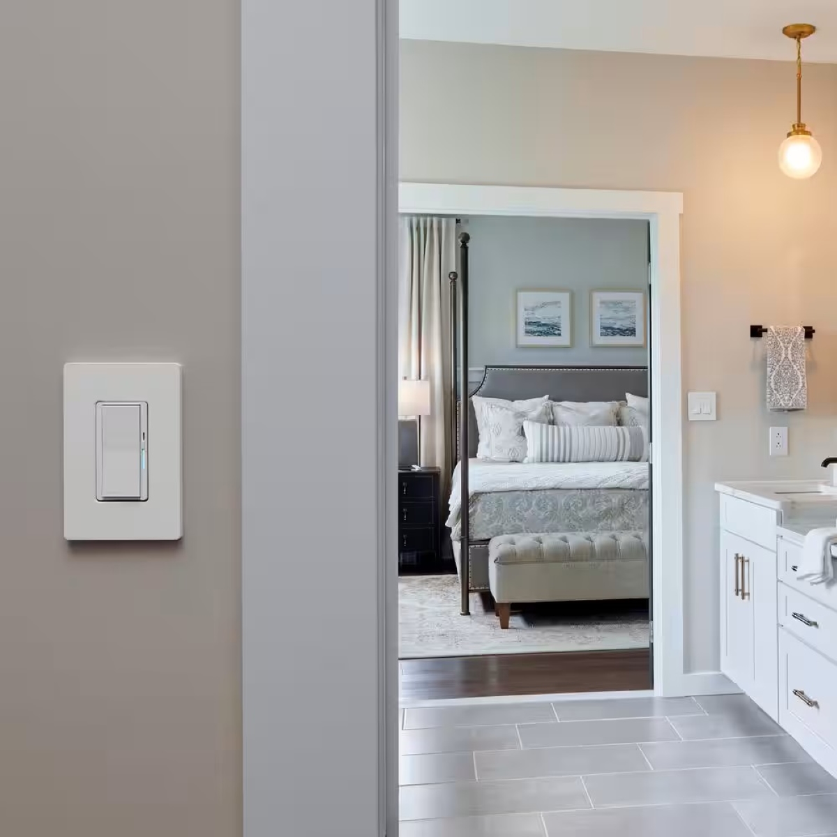 A view of a dimmer switch in the hallway looking into a bathroom and bedroom.