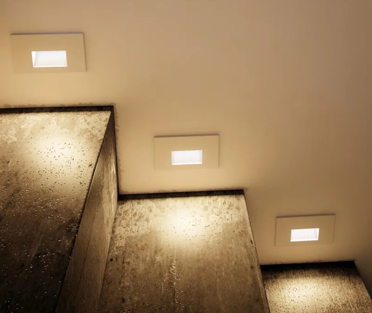 Concrete basement stair lighting.