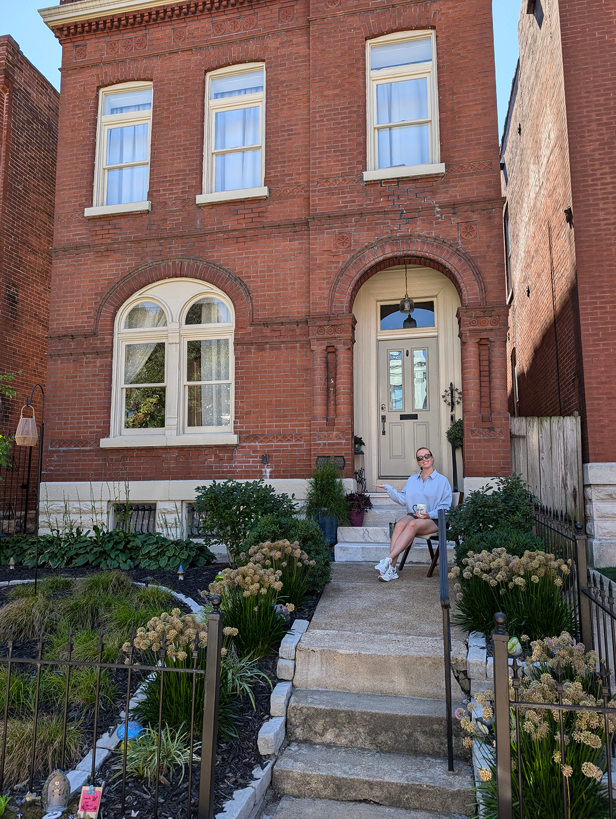 Emily M. in St. Louis sitting on her front porch looking at the native plants she used to replace her traditional turf lawn.