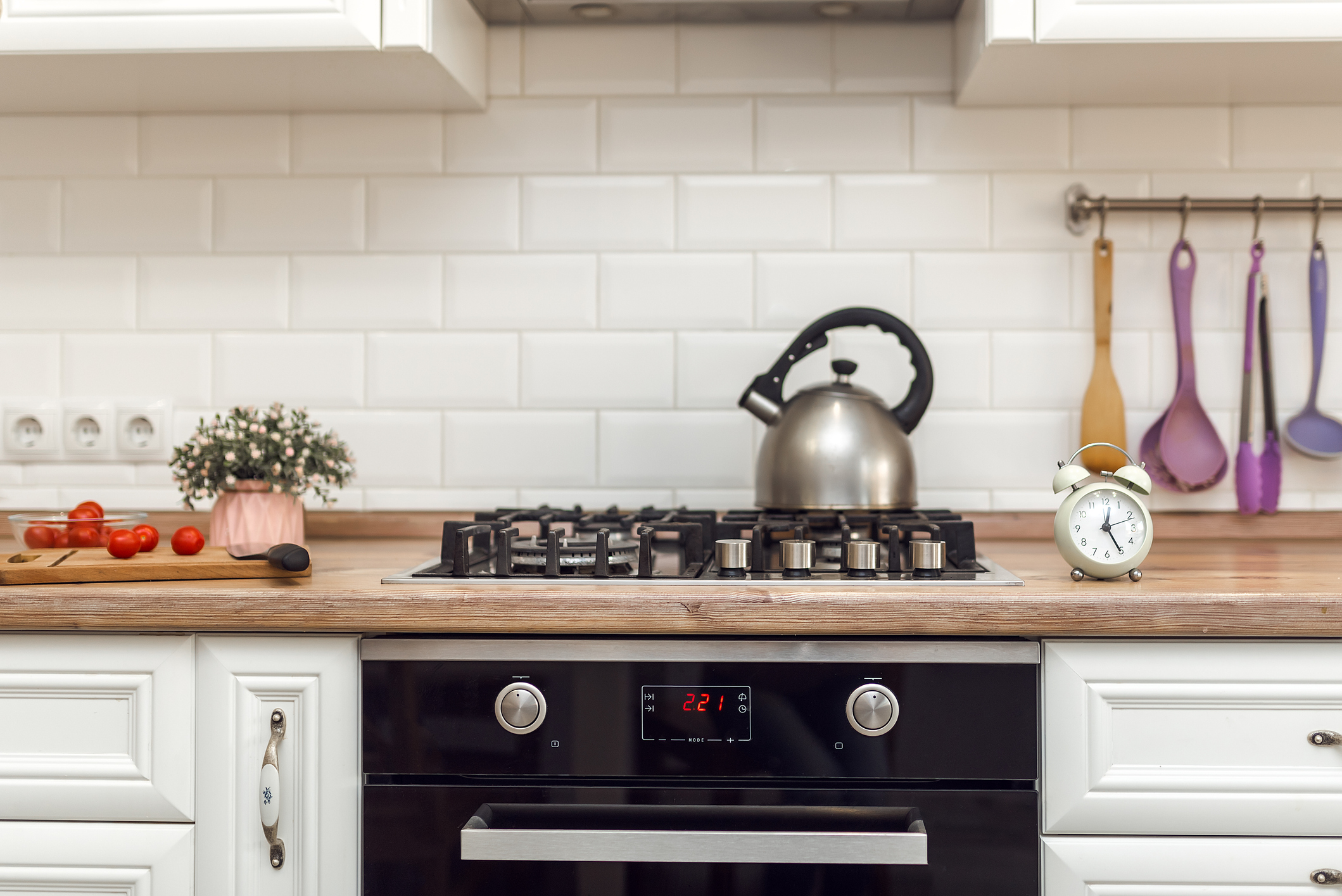 Modern gas stove with silver button controls.