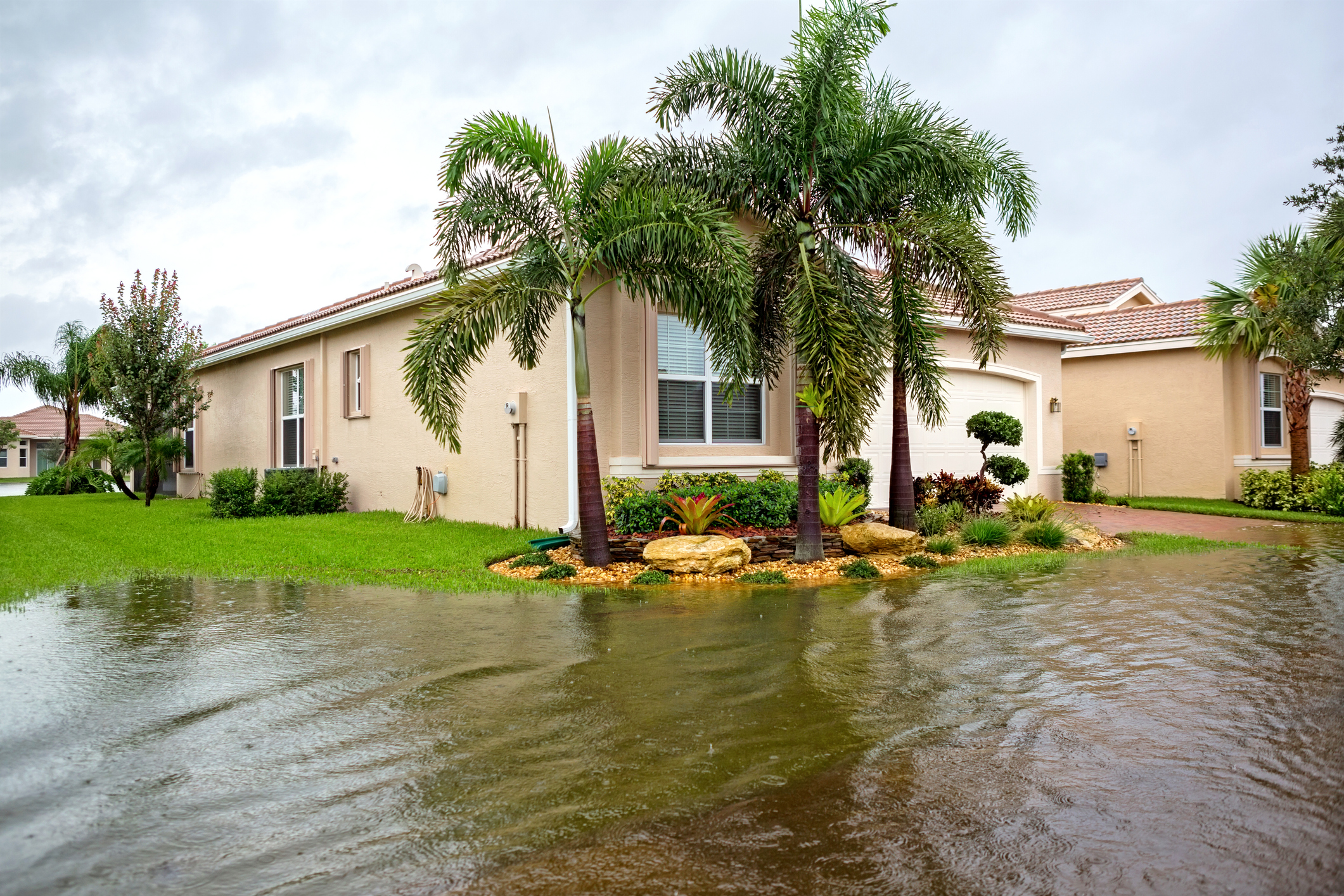 Outside view of a flooded house and street from a hurricane or tropical storm.