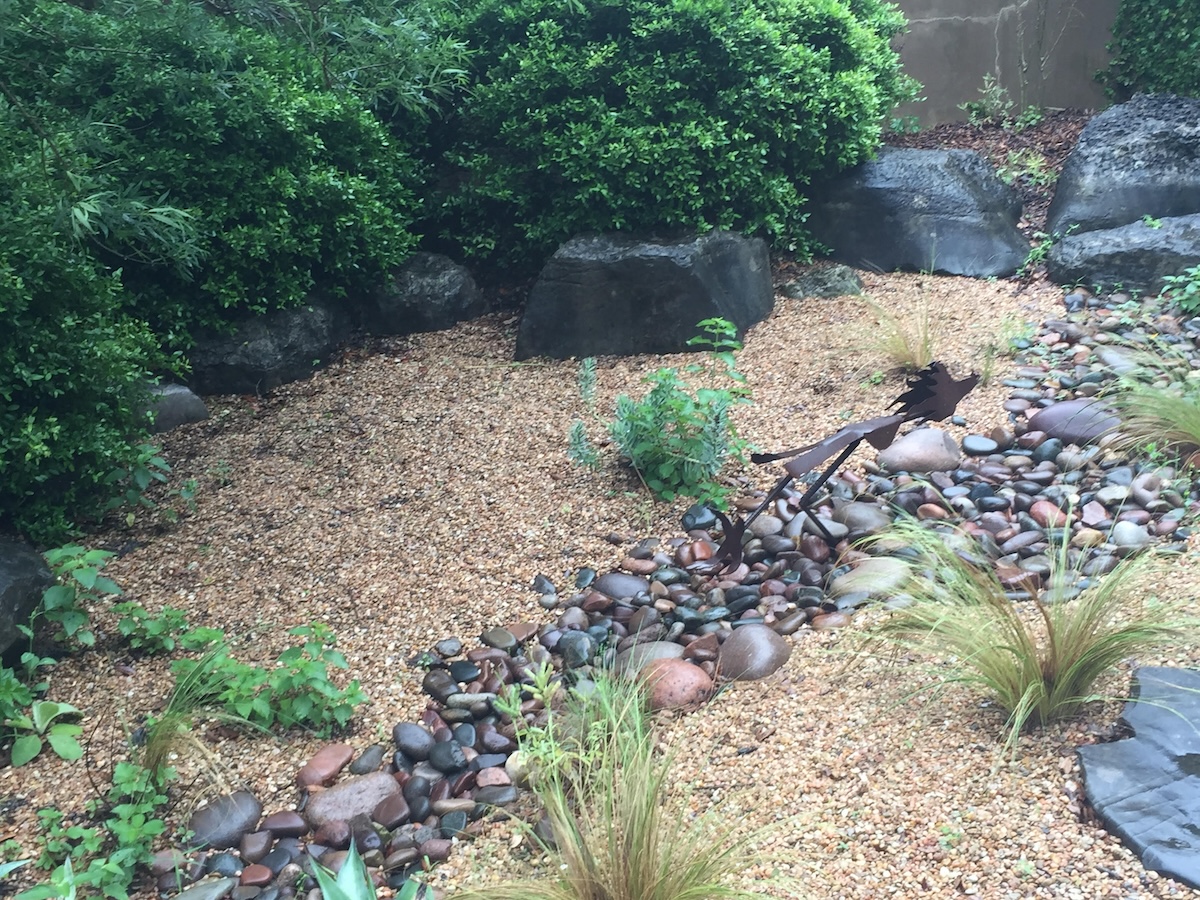 A dry creek bed hardscaping design in the desert southwest.