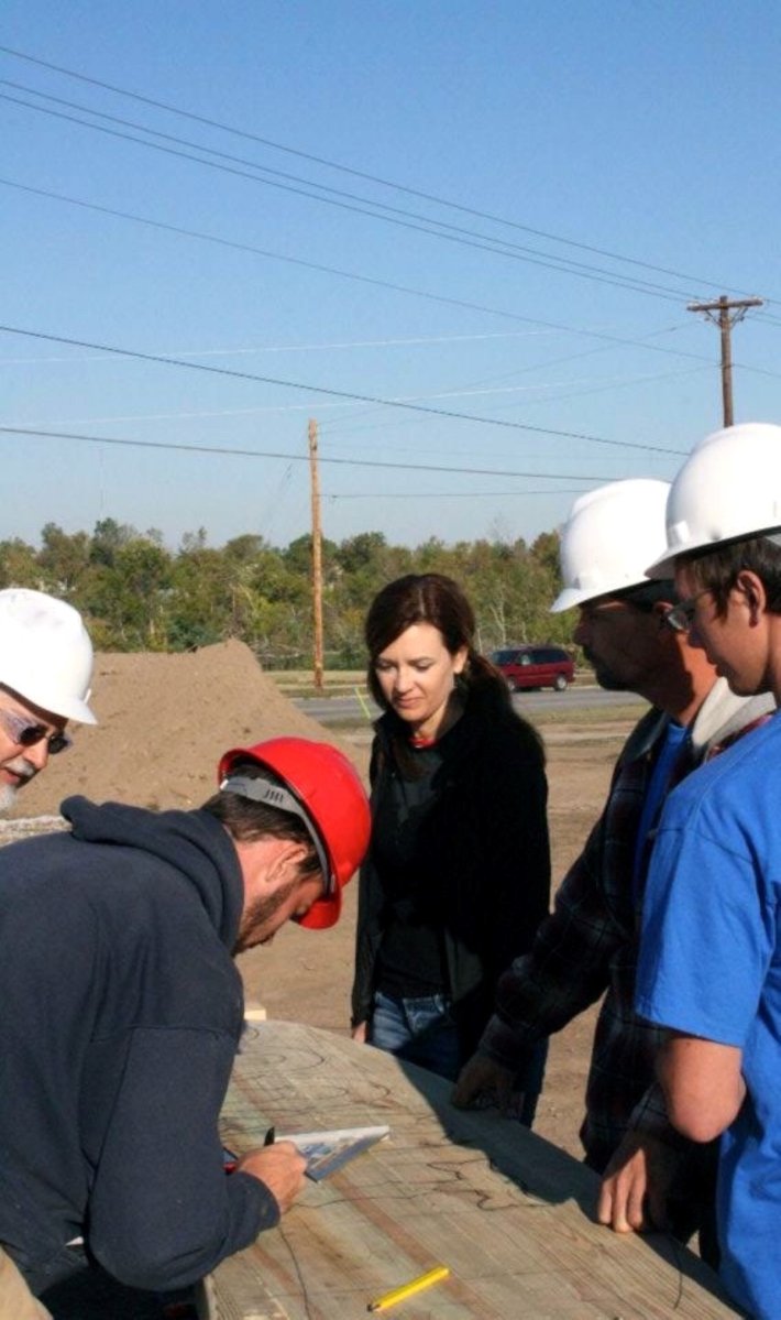 A group of people looking over design plans.