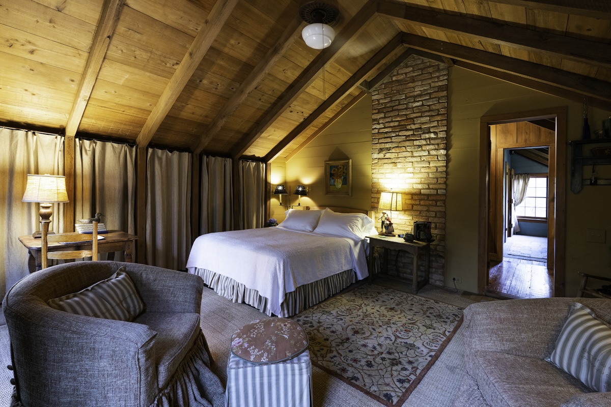 Large bedroom with wooden ceilings.