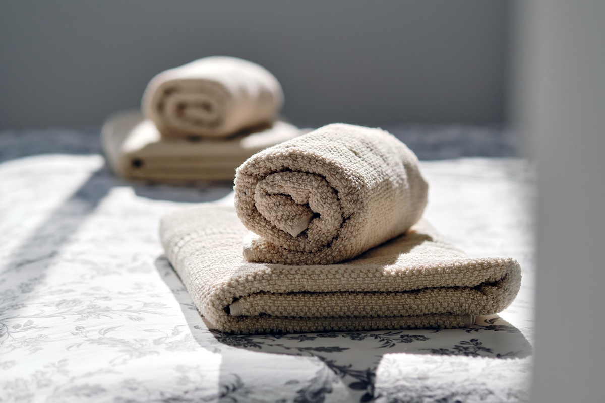 A set of freshly folded bathroom linens.