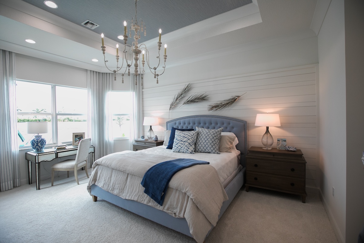 Primary bedroom with large windows and cool color scheme.