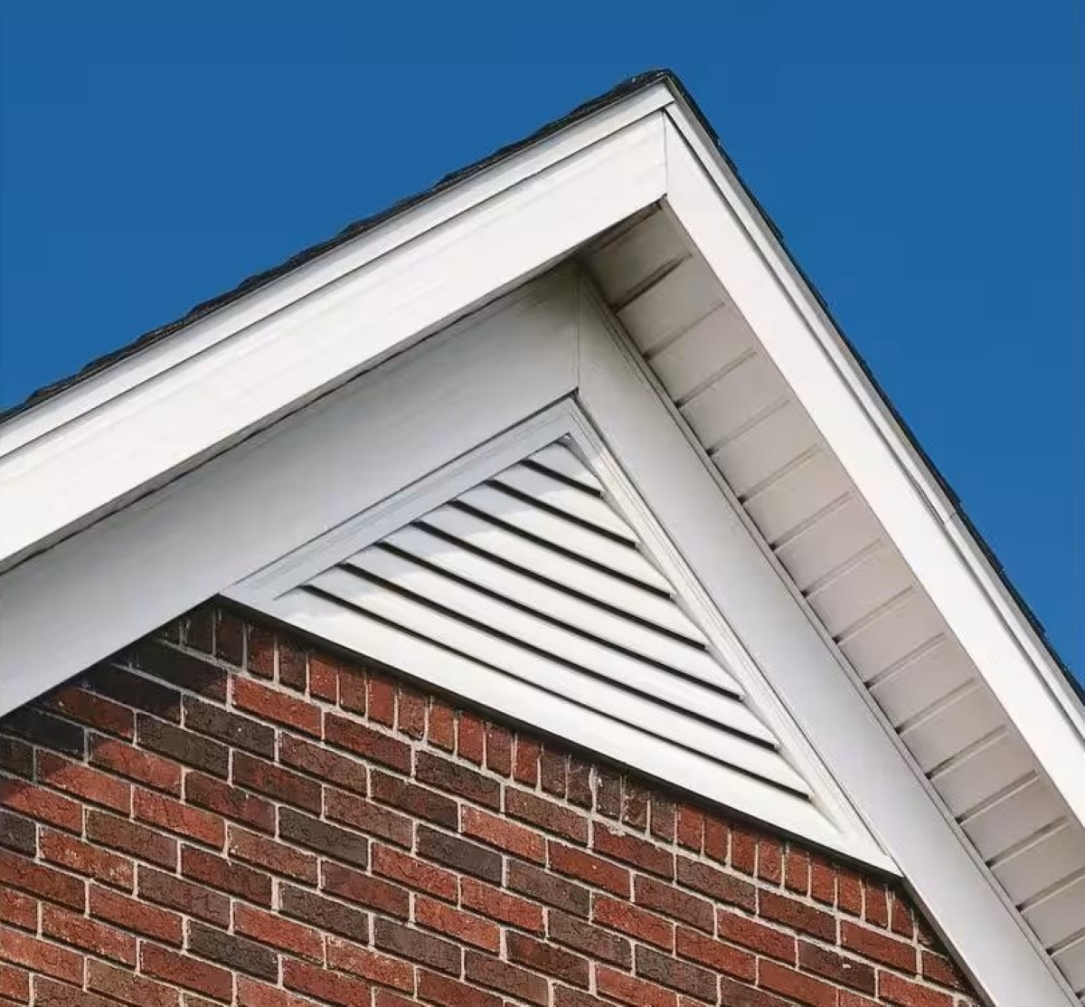 A triangle gable roof intake vent on top of the roof.