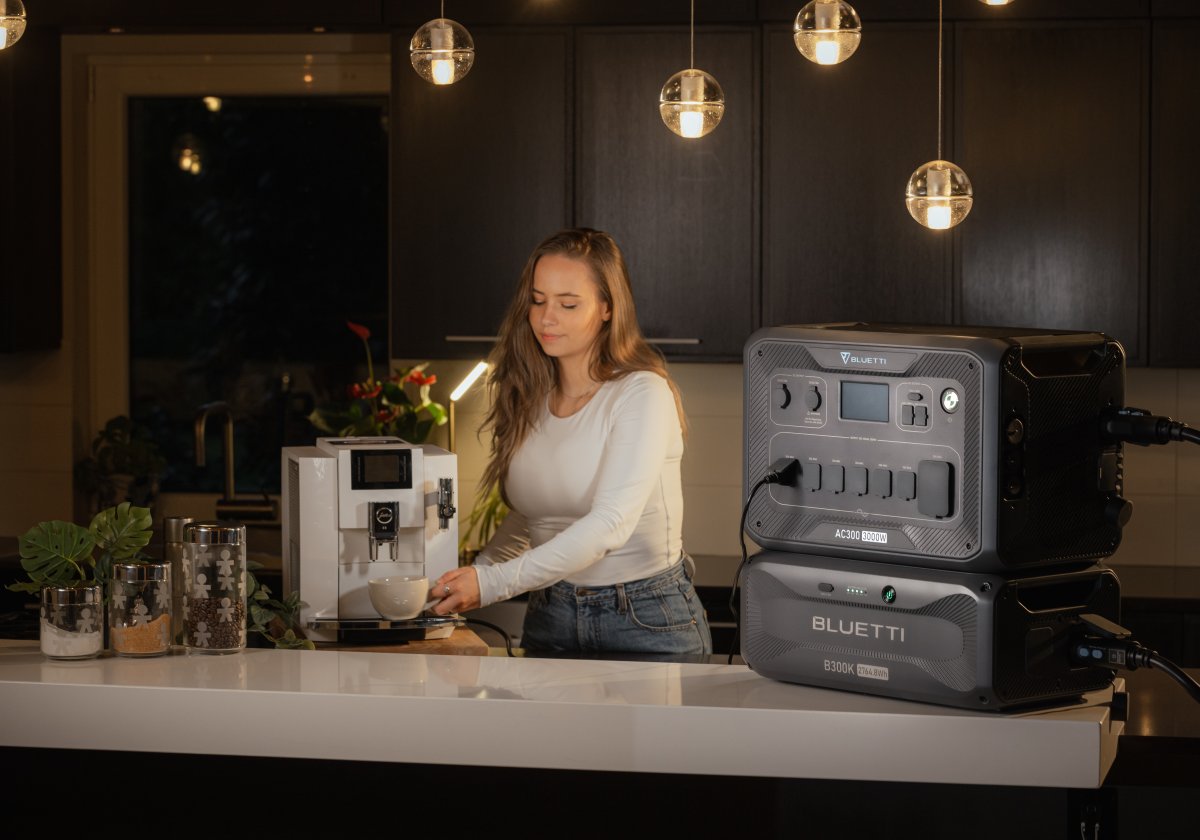 Woman using the Bluetti AC300 and B300K Home Battery Backup in the kitchen to power appliances