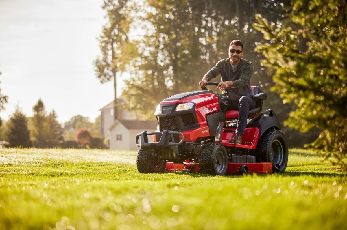 Man riding a Craftsman T4400 Mower in the yard