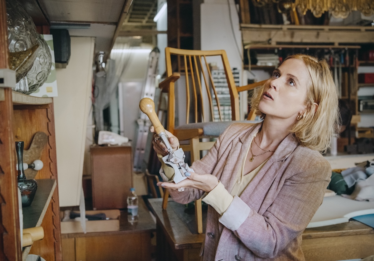 A person shopping in a secondhand furniture and decor store.