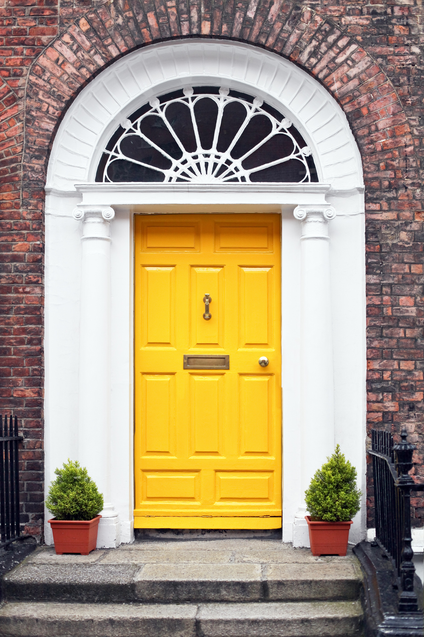 Front door of house painted canary yellow.