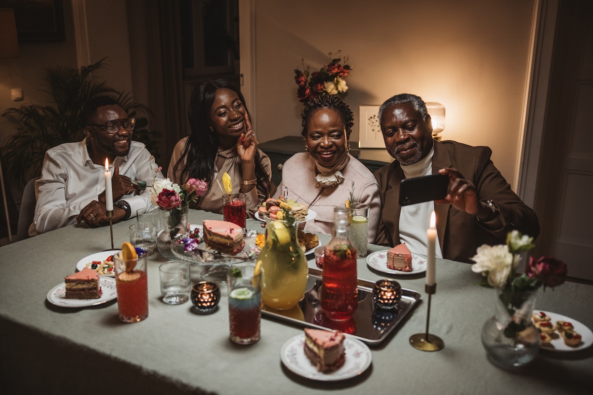 A family having a dinner party with dimmed lighting.