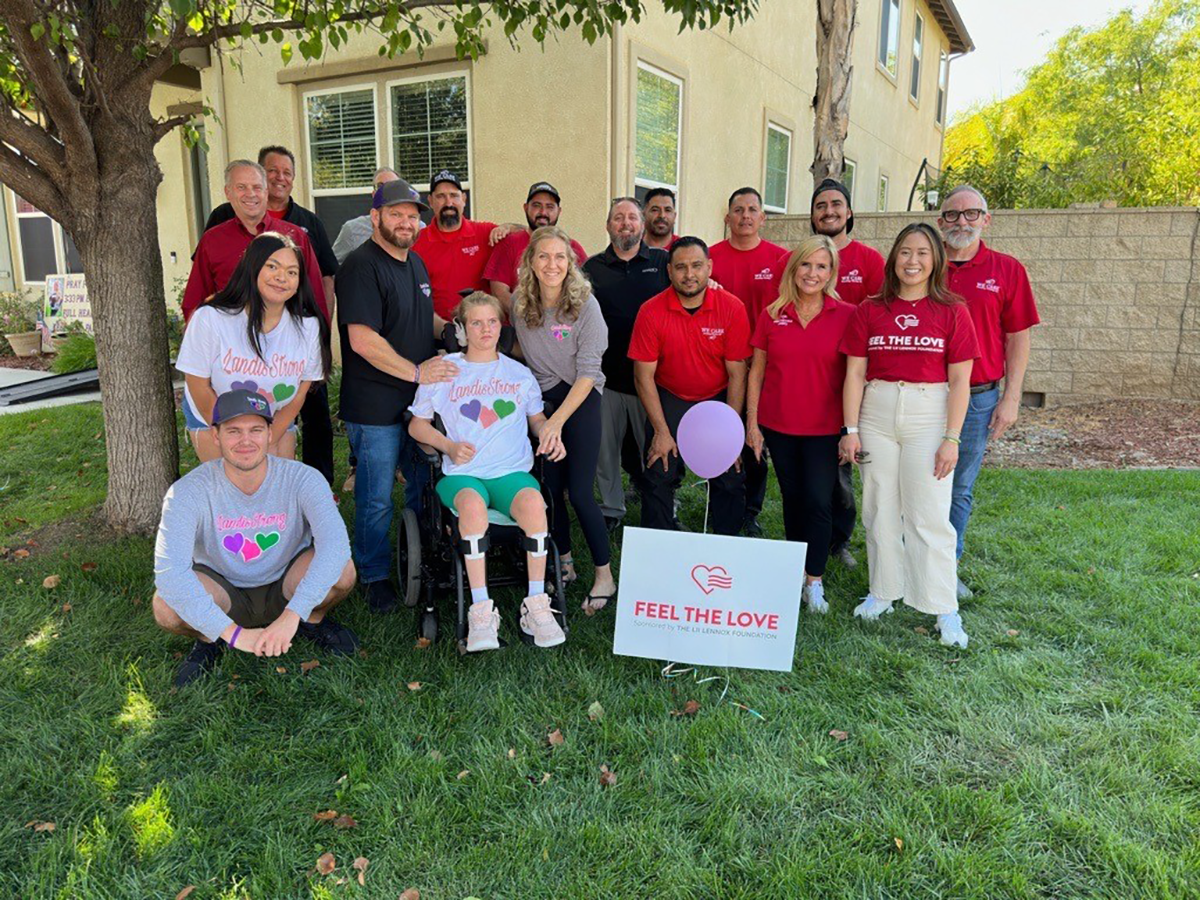 Lennox employees and HVAC installers with family receiving donation for the Feel the Love program 2024.