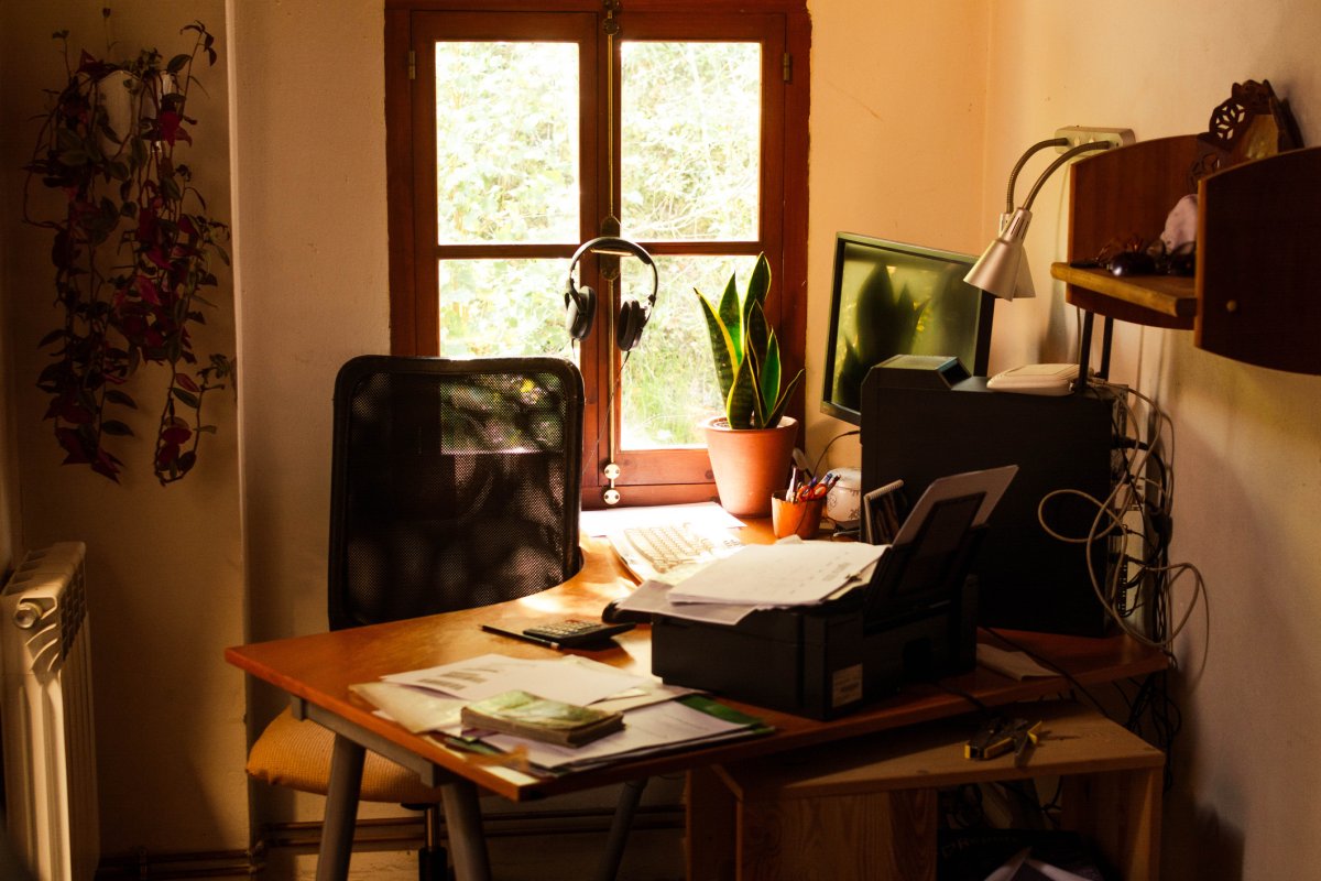 A small, cozy home workspace is tucked into the corner alcove of a room.