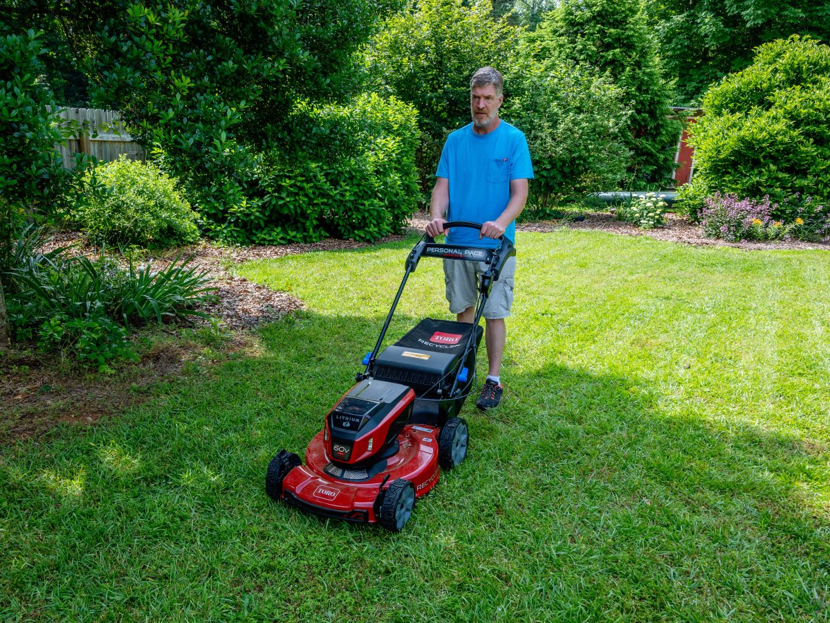 Man pushing the Toro recycler 60v lawn mower