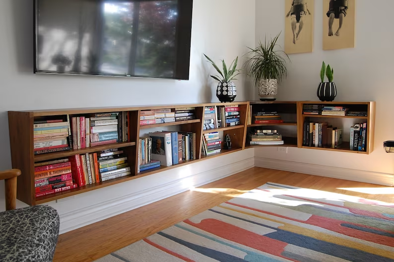 A set of floating shelves installed on a living room wall.