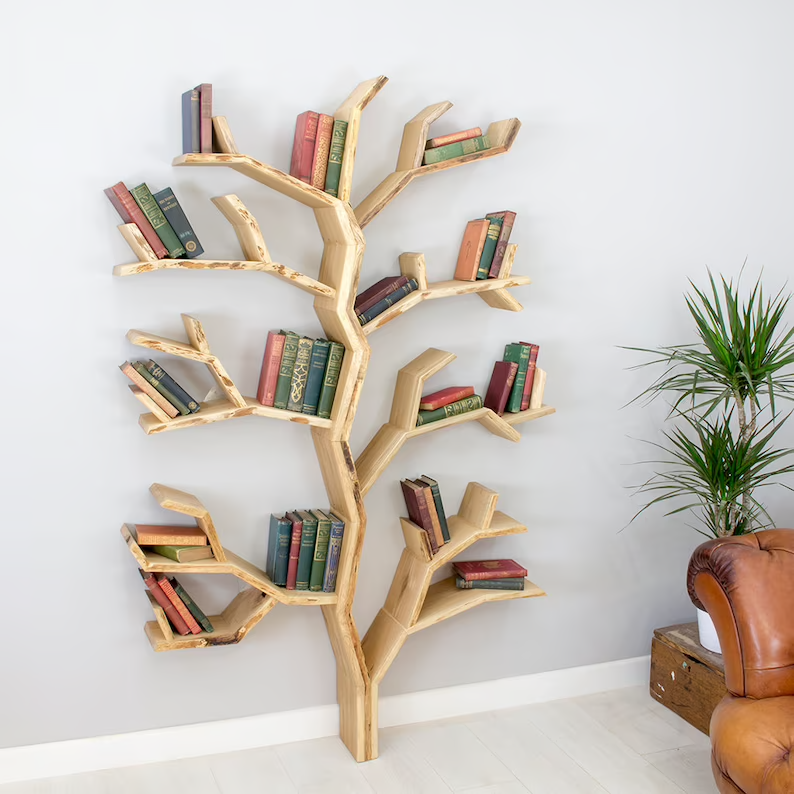 A tree-shaped built-in bookshelf installed on a wall holding several books on the branches.