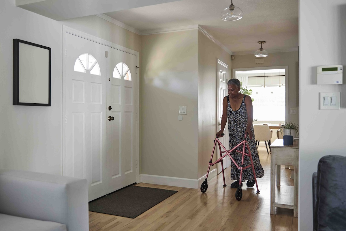 A person with a walker navigating her home for cleaning.