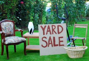 A selection of furniture and other items at a yard sale.