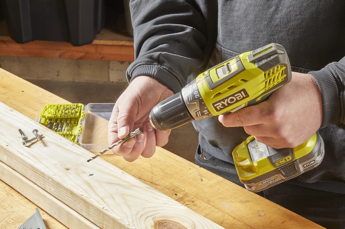 A DIYer loading a a drill bit into a drill/driver for home improvement projects and repairs.