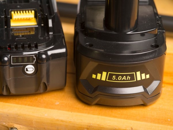 Lithium-ion power tool batteries on a garage workbench.