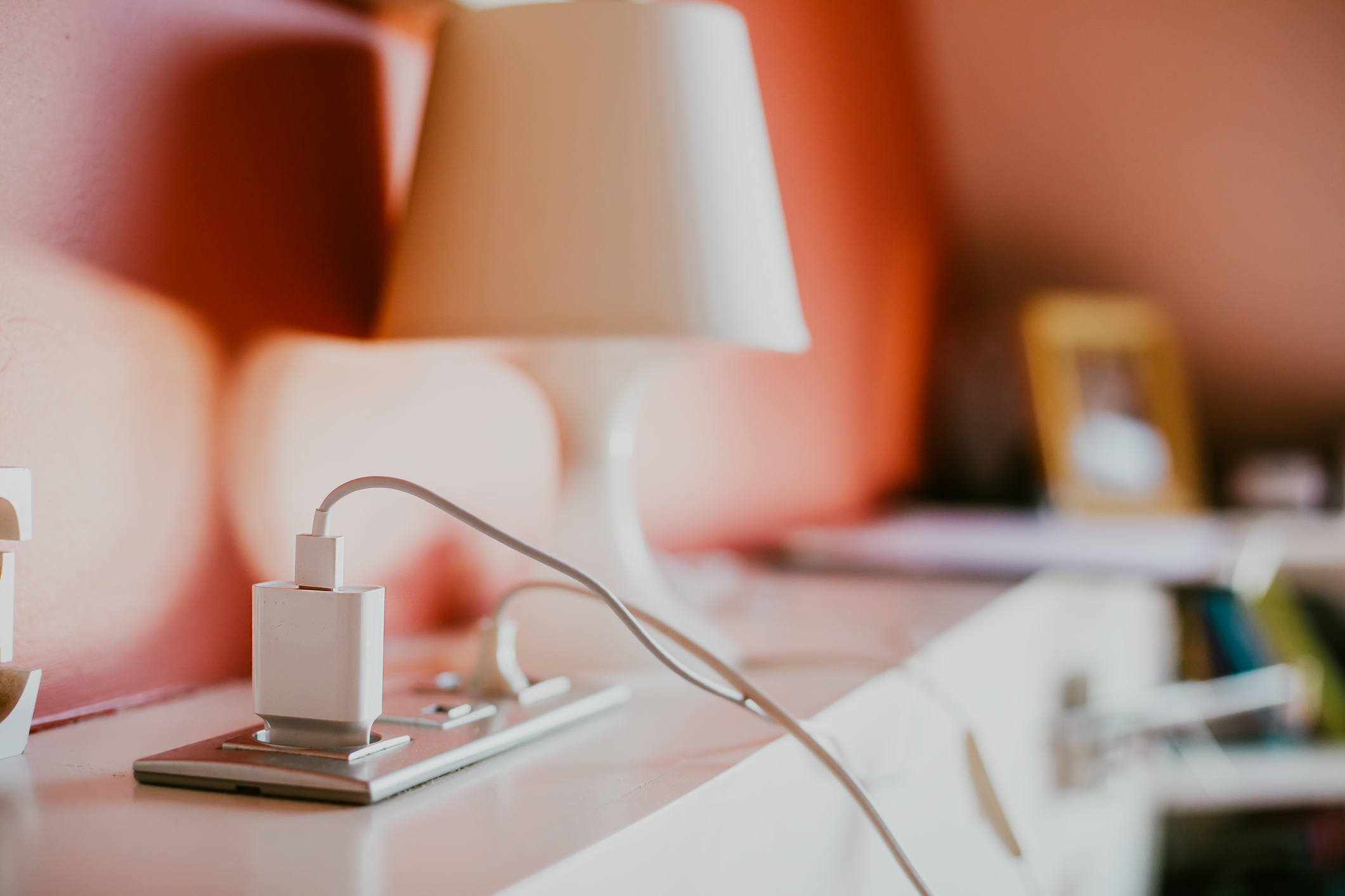 Electronics plugged in and charging in an electrical outlet.