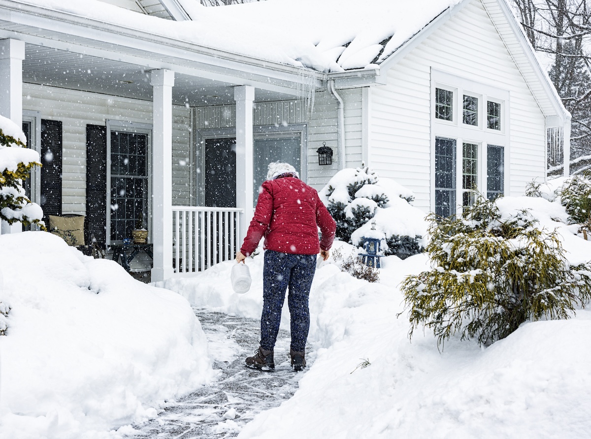 A homeowner using an ice melt alternative to keep outdoor surfaces safe.