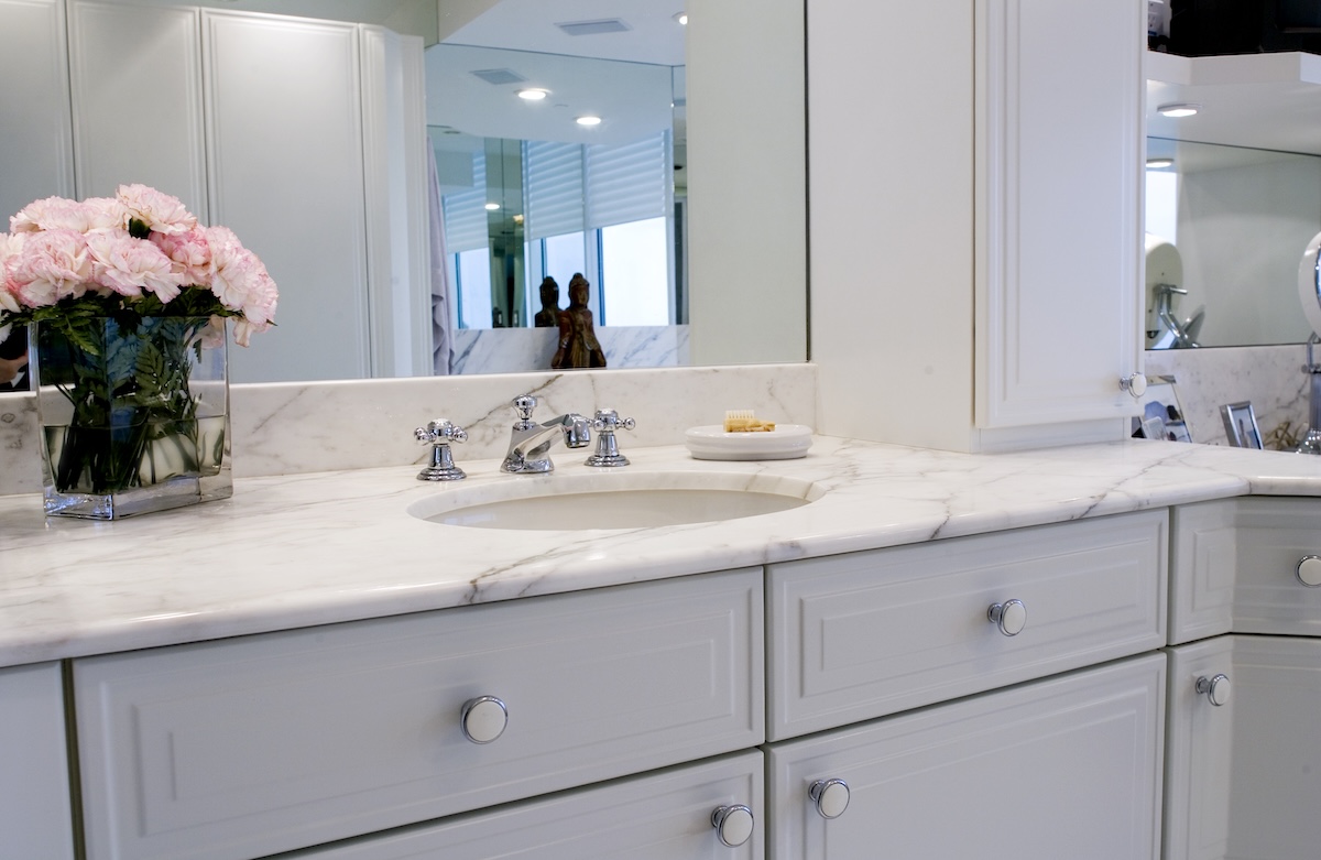 A clean marble countertop on a bathroom vanity.