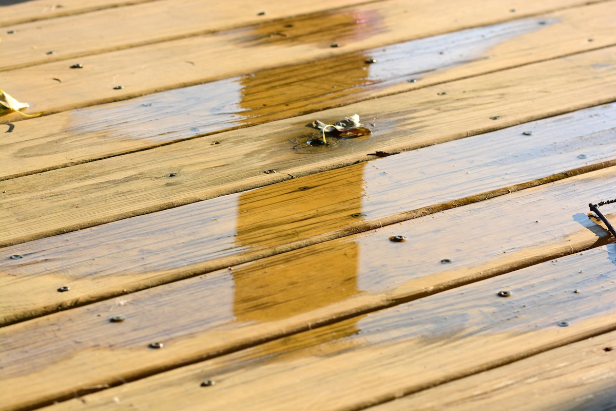 A deck surface with water pooling on decking.