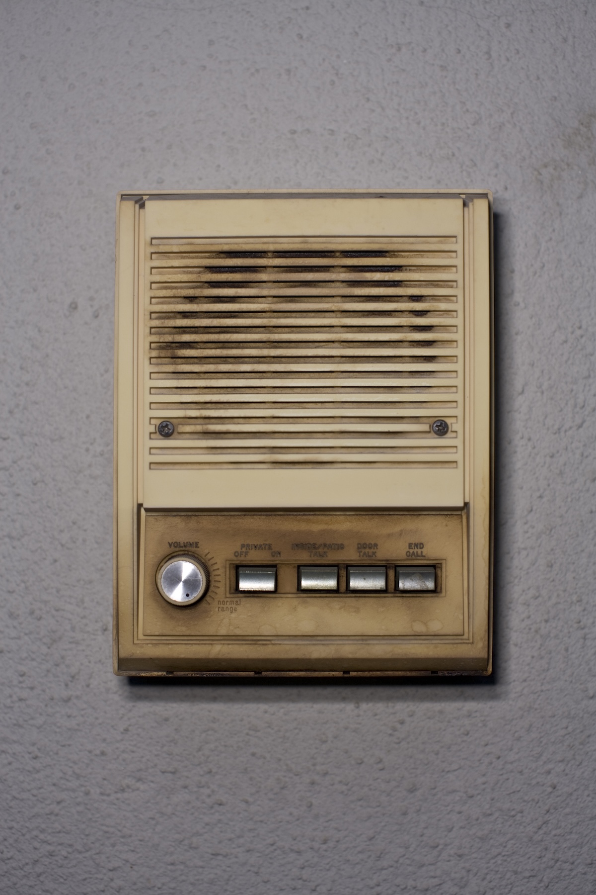 An old home intercom mounted on a wall.