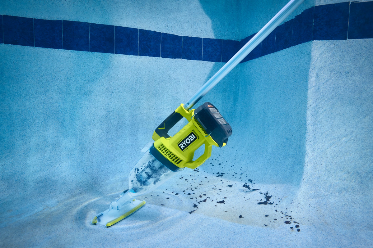 Person using Ryobi pool vac with pole to clean pool