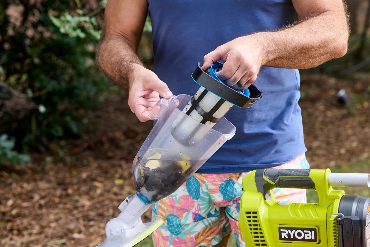 Person emptying Ryobi pool vac debris bin