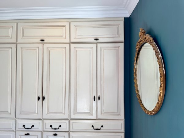 A wall of built-in stock cabinets making a custom wardrobe.