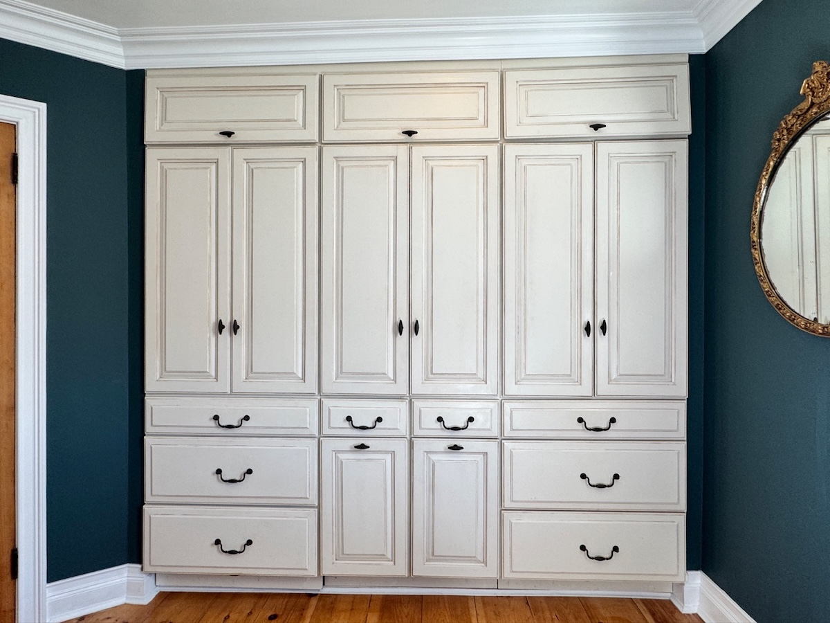 A wall of built-in cabinets making a wardrobe.