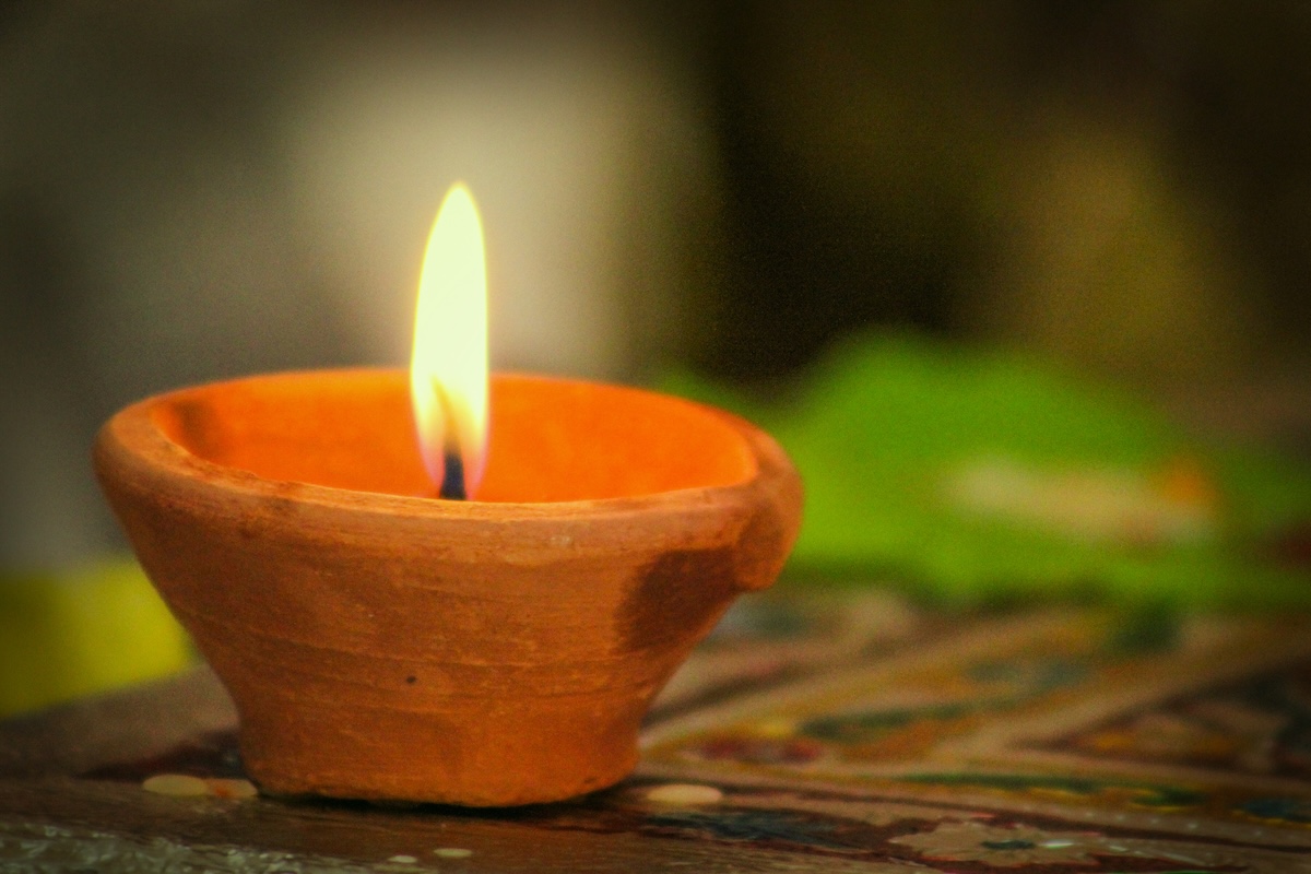 A terra-cotta pot used as a candle and indoor heater during a power outage.