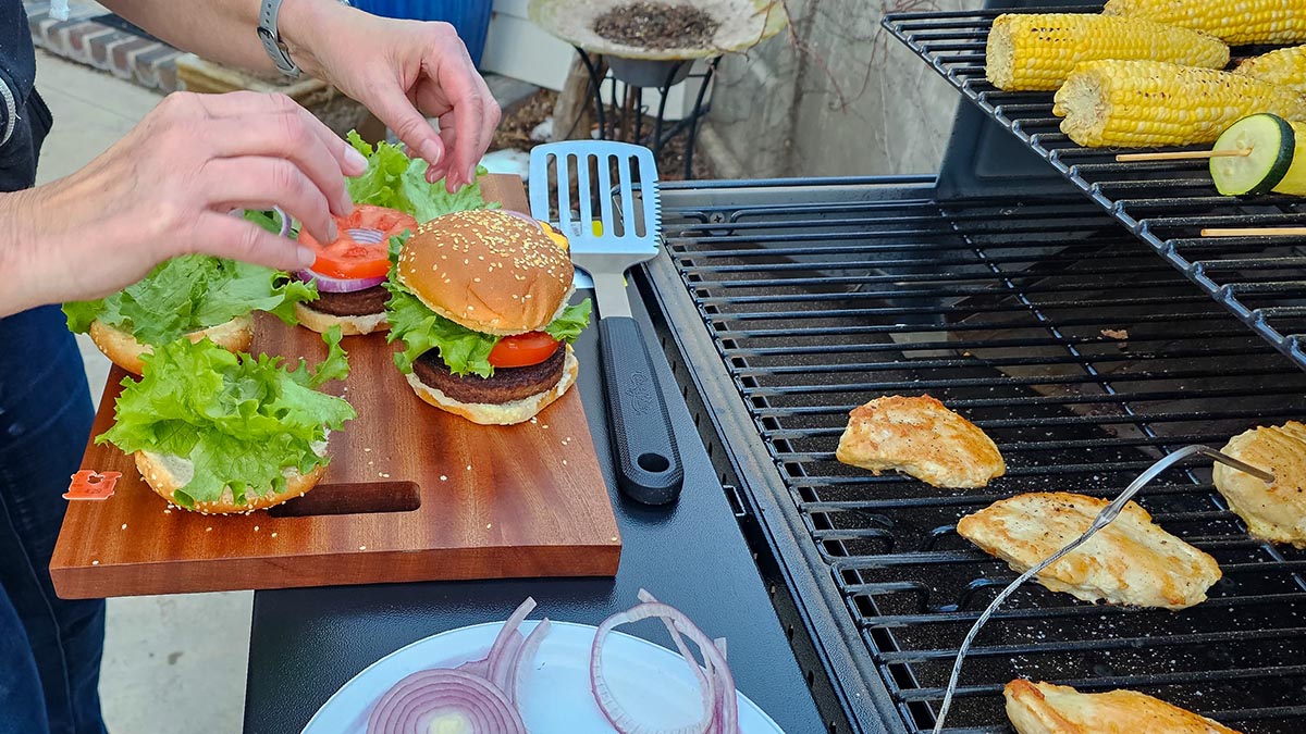 Traeger Review Assembling burgers on the table of the Traeger Woodridge