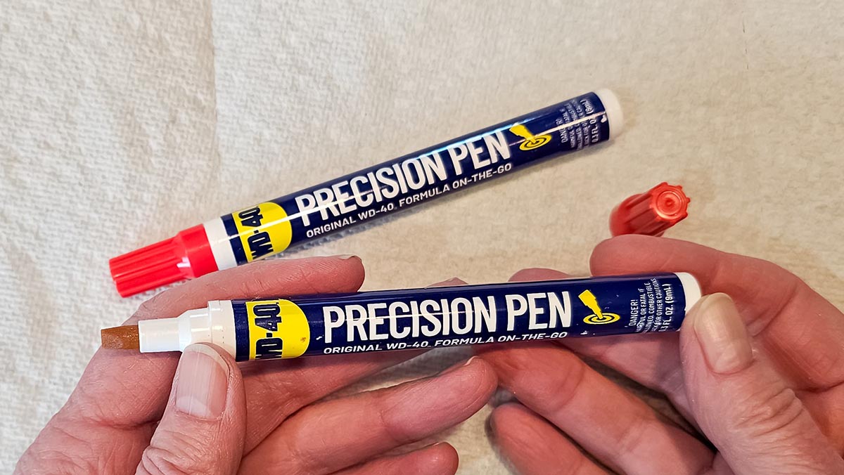 WD-40 Pen Review Holding a WD-40 Precision Pen with another one laying near