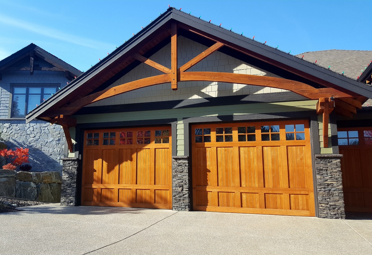 A craftsman style home with cherry garage doors.